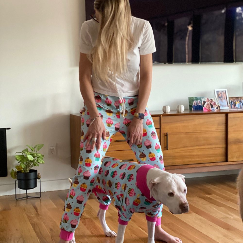 foster dog and their mom in matching pajamas